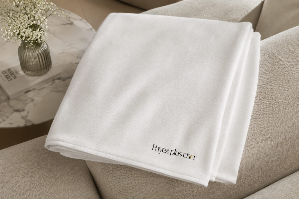 Plaid blanc déplié sur un fauteuil, cadeau hors de prix